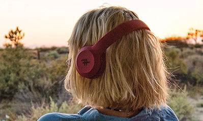 A women wearing maroon headphones