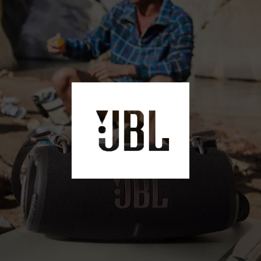 Jbl logo overlaid on a jbl speaker with a man sitting in the background